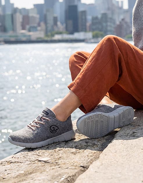 Grey Giesswein Merino Runners worn by the waterfront