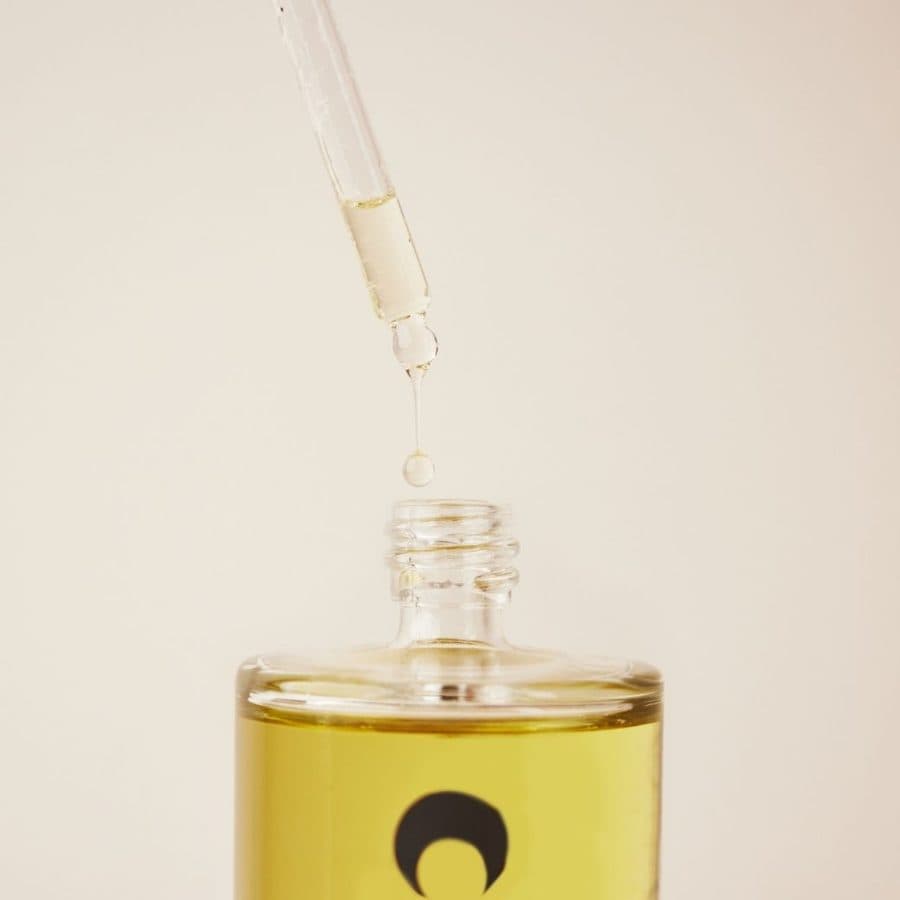 Dropper over a bottle of Lumity body oil